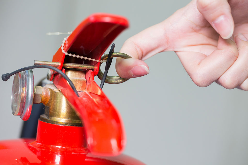 Close- up Fire extinguisher and pulling pin on red tank